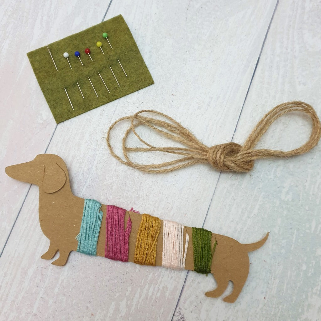 A dachshund motif cut from kraft card, styled as an embroidery thread organiser