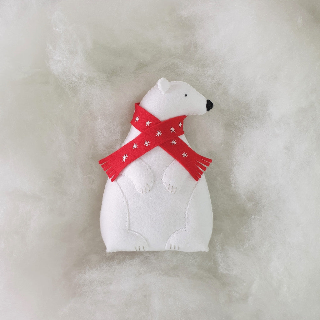 a felt polar bear sitting on soft fluffy stuffing
