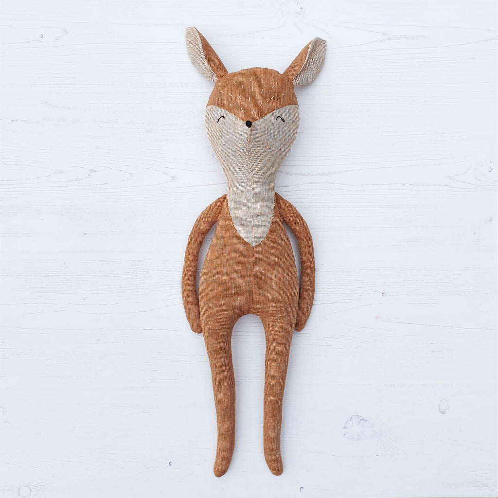 A vintage style handmade deer soft toy, featuring Robert Kaufman essex linen fabrics.